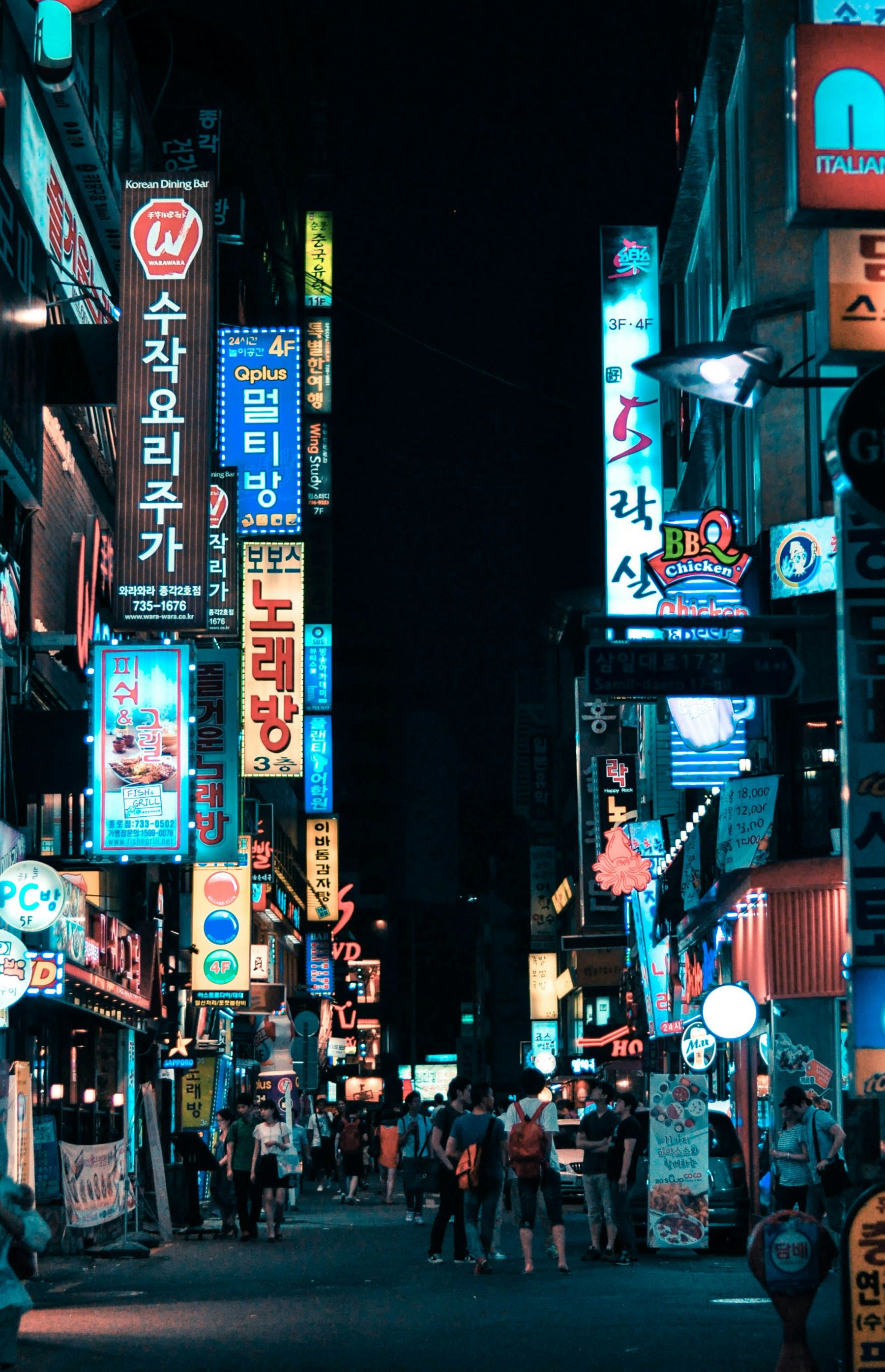 A Seoul street at night, lit by Korean neon signage